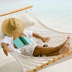 man relaxing in a hammock at the Caribbean beach